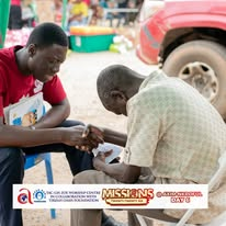 A medical volunteer examining a community member during outreach