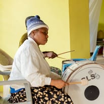 A woman playing a drum during a worship gathering