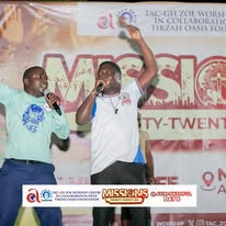 Mission participants singing together at an Axim worship event